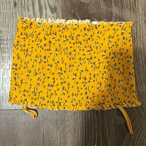 Yellow tube top, ribbed with flower designs.